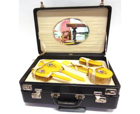 AN UNUSUAL COMBINATION OVERNIGHT CASE, TRAVELLING TOILET CASE the upper section fitted with plastic brushes, comb, nail file 