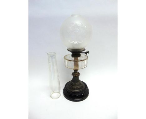 A VICTORIAN OIL LAMP with clear facetted glass reservoir on metal and ceramic base, together with a matched glass shade and f