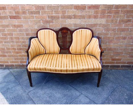 AN EDWARDIAN MAHOGANY FRAMED SALON SOFA with inlaid marquetry decoration