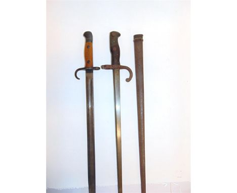 TWO BAYONETS comprising a French Gras sword bayonet, the 52cm t-section steel blade marked to the back edge 'Paris - Oudry - 