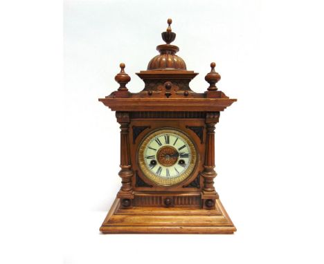 A GERMAN WALNUT CASE MANTLE CLOCK with 8-day striking movement, the architectural case 43cm high, 15.5cm deep, 26cm wide
