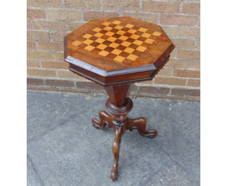 A VICTORIAN ROSEWOOD GAMES/WORK TABLE the octagonal top inlaid with chess board, opening to reveal original green paper lined