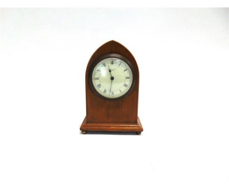 LIBERTY & CO: AN EDWARDIAN MANTLE CLOCK, in lancet shaped mahogany case with line inlaid decoration, the 3.5' white enamelled