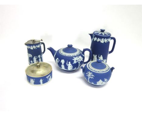 FIVE ITEMS OF WEDGWOOD BLUE GROUND JASPERWARE each with typical sprigged decoration, the teapot 12.5cm high