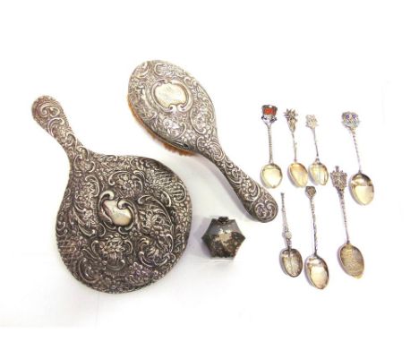 A SMALL SILVER TRAVELLING INKWELL a silver hand mirror; a silver hair brush; and seven assorted souvenir spoons