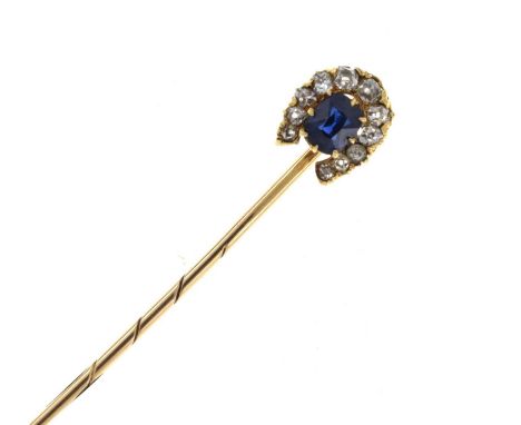 A sapphire and diamond horseshoe stick pin, the horseshoe of eleven graduated old brilliant cut diamonds enclosing the oval c