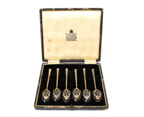 Garrard &amp; Co Ltd retailer - Cased set of six Elizabeth II silver teaspoons, the gilt bowls having enamel decoration to th