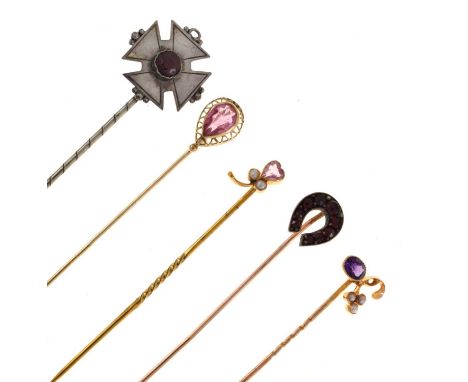 A stone set horseshoe stick pin; a single stone stick pin; an amethyst and seed pearl stick pin; a heart shaped stone and see