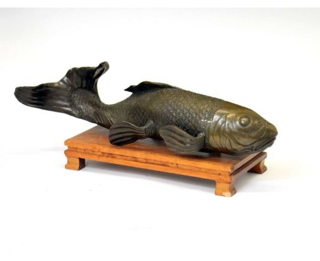 Japanese bronze model of a Koi carp, the fish with well-modelled scales, incised mark beneath, 30cm long, with wooden stand