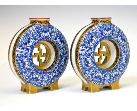 Pair of late Victorian Royal Worcester miniature moon flasks, each of tubular section painted with underglaze foliate scroll 
