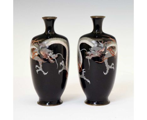 Pair of Japanese Meiji period cloisonné enamel vases, of shouldered ovoid form, decorated with trailing dragons on a black gr