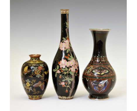 Three 20th Century Japanese black ground cloisonné enamel vases, comprising an ovoid example with attenuated neck decorated w