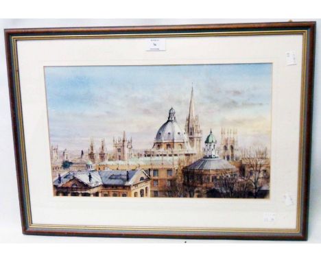 A framed coloured print, depicting cathedral spires and other rooftops