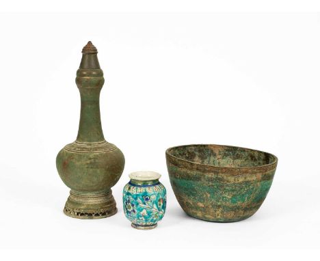 An Asian or Middle Eastern bronze vase and cover, 38.5cm high, a circular bronze bowl, 25cm diameter and Qajar pottery vase, 