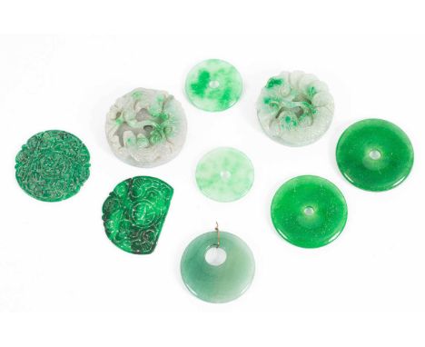 Two carved jade roundels depicting lizards among foliage, each 5.5cm diameter and various jade roundels etc.One dark green ro