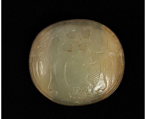A carved oval jade plaque, decorated as a fruiting branch and mounted as a brooch with white metal, 7.5cm x 6.5cm