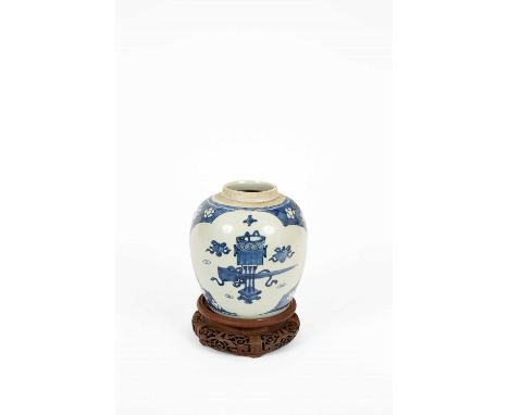 A Chinese blue and white ginger jar, Kangxi, painted with panels of precious objects on a prunus ground, 17.5cm high excludin
