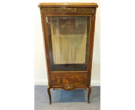 An early 20th century Louis XVI style marble-topped kingwood and gilt-metal-mounted vitrine; single glazed door above vernis 