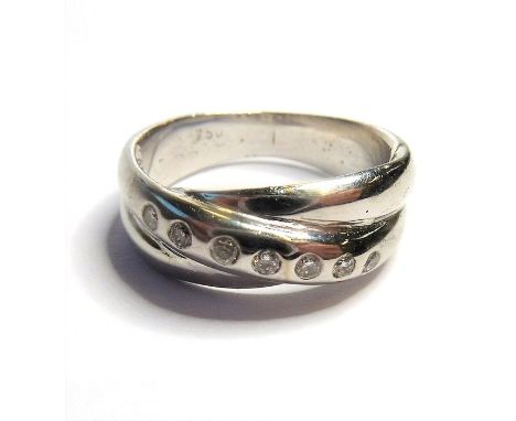 A crossover-style 18-carat gold ring set with seven diamonds (approx. weight 6g)(The cost of UK postage via Royal Mail Specia