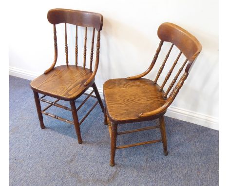 A pair of late 19th/early 20th century kitchen-style chairs; each with concave top rail above turned and bobbin-turned spindl