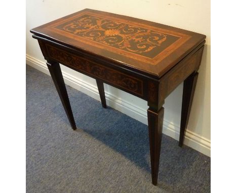 A late 18th/early 19th century Italianate rosewood fold-over top card table; marquetry frieze and the fold-over top headed wi