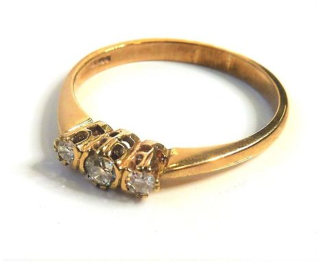 A gold three-stone diamond ring&nbsp;(The cost of&nbsp;UK postage&nbsp;via Royal Mail Special Delivery for this lot will be £