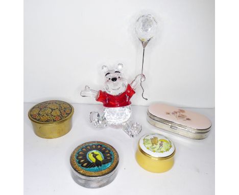 A small hand-cut crystal model of Winne the Pooh holding a balloon together with four small pill/patch boxes to include a cir