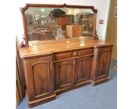 A mid-19th century mahogany pedestal sideboard; the mirrored back above a thumbnail-moulded top and central recessed drawer a