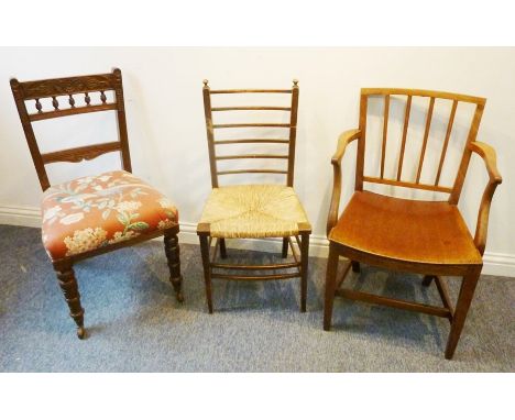 A George III period mahogany open armchair in Sheraton style with saddle seat and square tapering legs, one further Arts &amp