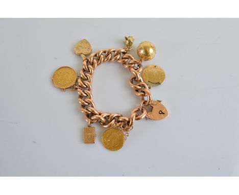 An early 20th Century 9ct gold heavy curb link bracelet, with padlock clasp, with various novelty charms, including an early 