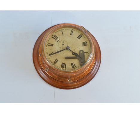 A late 19th Century 30 hour bulkhead wall clock, with roman numerals, second subsidiary dial on a later mahogany carved mount