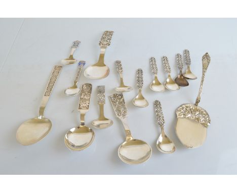 A collection of Norwegian silver commemorative serving spoons,  including an enamel example, another commemorating the city o