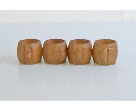 A set of four Robert Thompson Kilburn 'Mouseman' octagonal carved napkin rings, 5cm high x 6cm diameter to include mouse