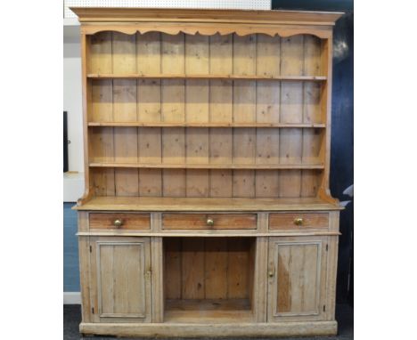 A late 19th Century pitch pine dresser, the base fitted with three frieze drawers over central dog kennel flanked by two pane