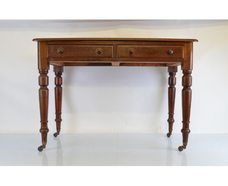A Victorian walnut two drawer wash stand, having turned supports, raised back all on ceramic and metal castors, 106cm x 50cm 