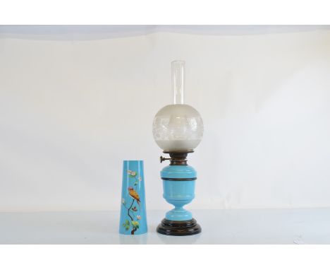 A Victorian turquoise glass oil lamp, with frosted floral decorated circular shade on glass black plinth base, 61cm high toge