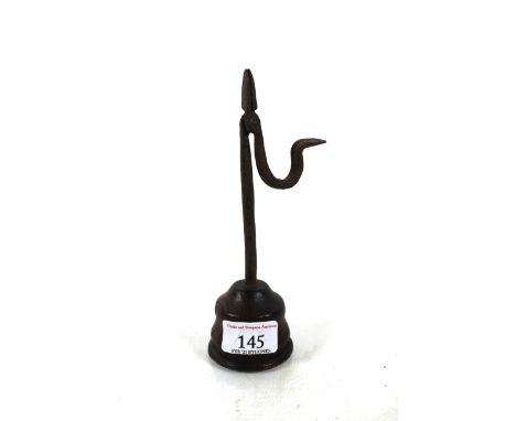 A small 19th Century wrought iron rush light on a turned oak base