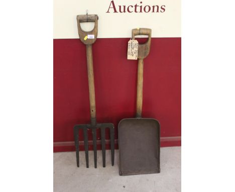 Two grain tools originally from Isaac Lords Maltings in Ipswich, a large metal shovel and a five pronged wooden handled metal