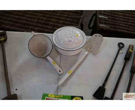 A circular enamel roasting pot and two enamel tools 