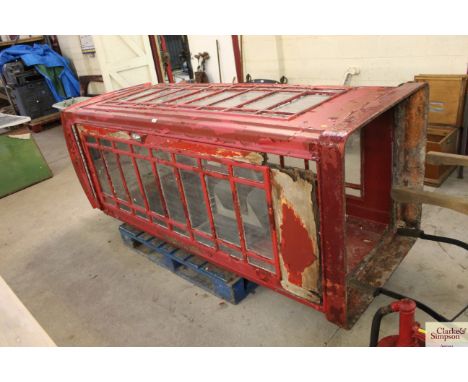 A vintage telephone kiosk/ phone box with spares to include four larger glass windows, two door check straps, one door hinge,