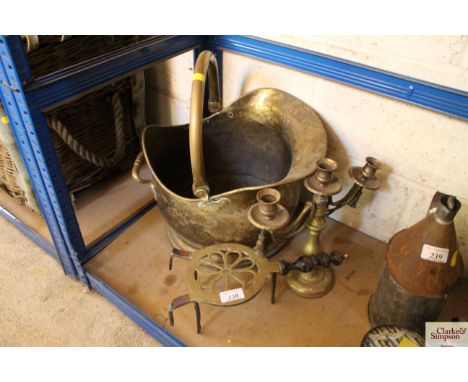 A brass coal bucket, a brass trivet and a brass three branch candelabra