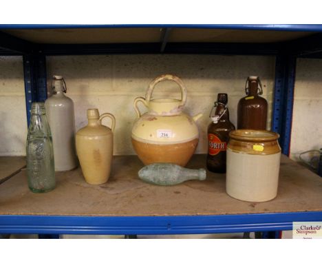 A quantity of stoneware bottles, an olive jar, terracotta jug, vintage bottles etc.
