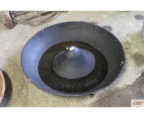 A large circular cast iron pig trough AF