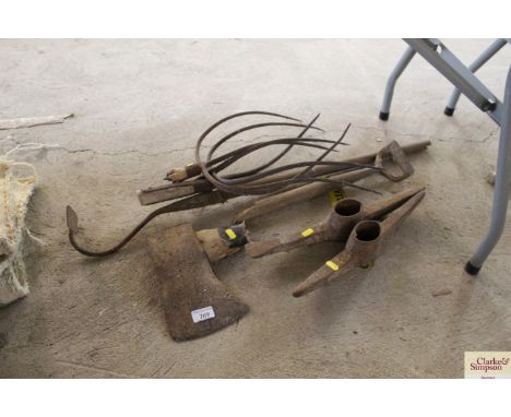 An axe head, two pick heads, fork heads etc.