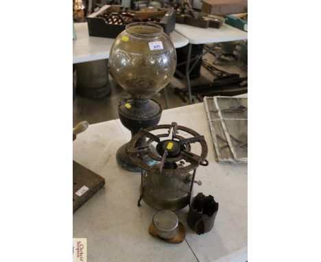 An oil lamp with ornate glass shade and a small Primus stove etc.