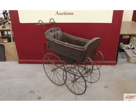 A vintage twin seated and wooden carved pram