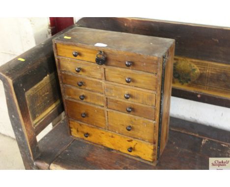 A small lockable nest of drawers and contents of screws, chain, springs etc. 