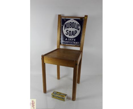 A chair with the enamel double sided Watson Soap sign and a bar of Watson Matchless Cleanser Soap
