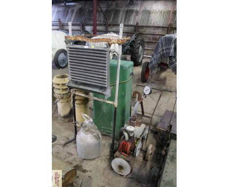 A Lister Cool milk cooler stand, a Miracle milker on trolley - sold as a collector's item and a milk churn with cluster fitti