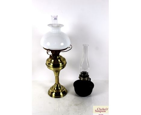 A brass table oil lamp with shade and a Bialladin lamp with chimney